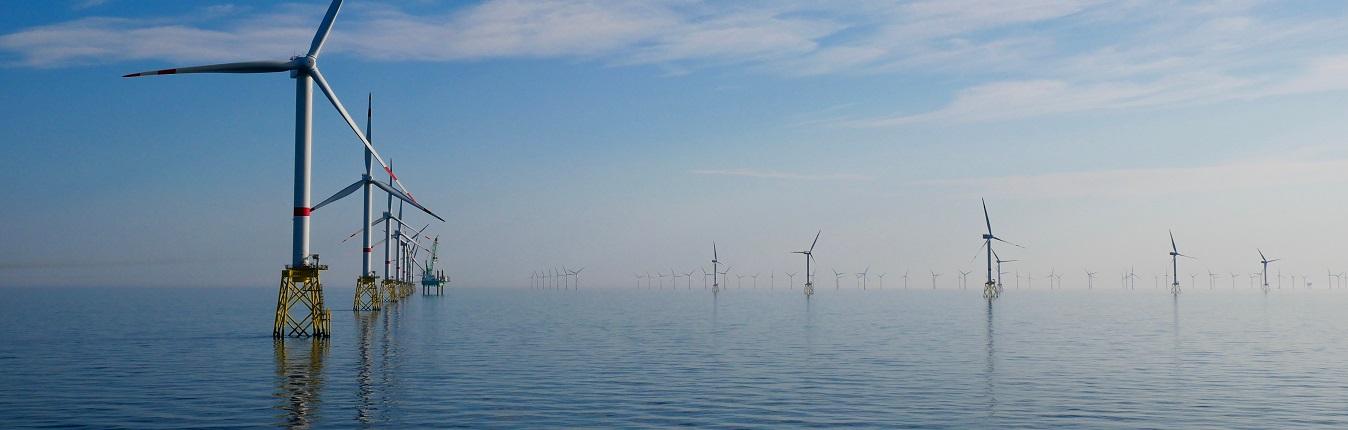 Distant view of offshore wind turbines in the sea